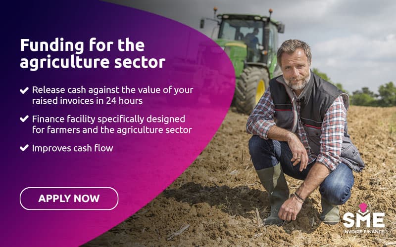 Farmer in a cultivated field with a tractor, representing UK agriculture and farming.