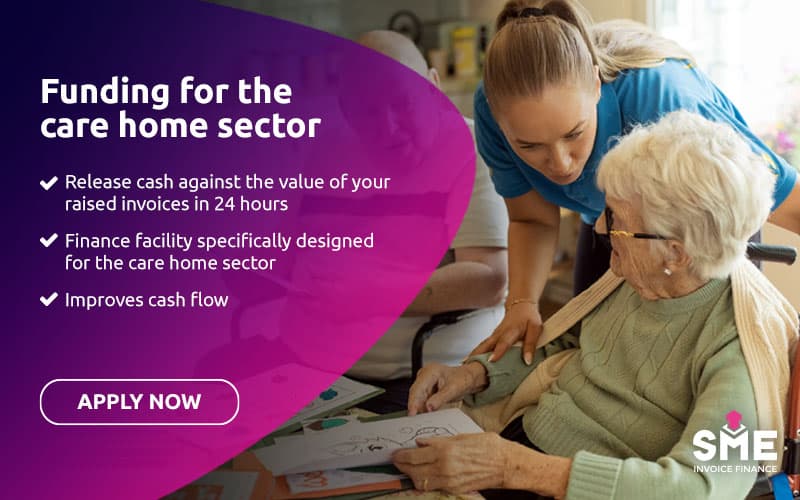 Care worker supporting an elderly resident in a care home.